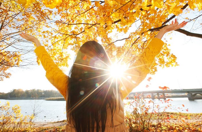 Junge Frau nutzt die Herbst-Sonne.
